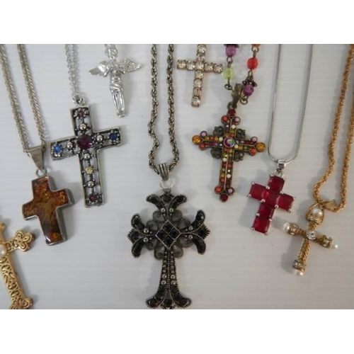 305 - Nine assorted cross pendants.