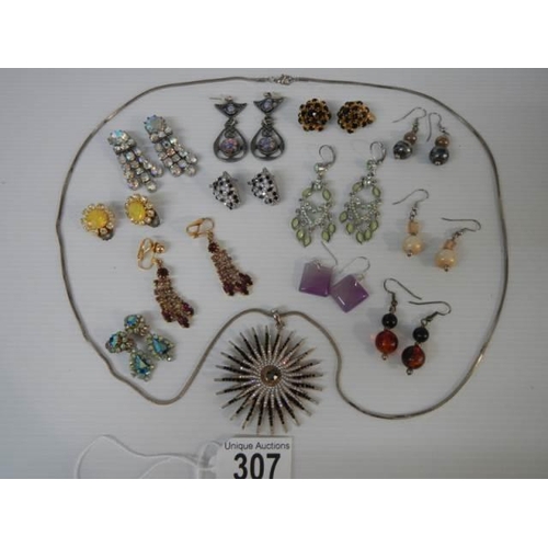 307 - A sunburst pendant and twelve pairs of assorted earrings.