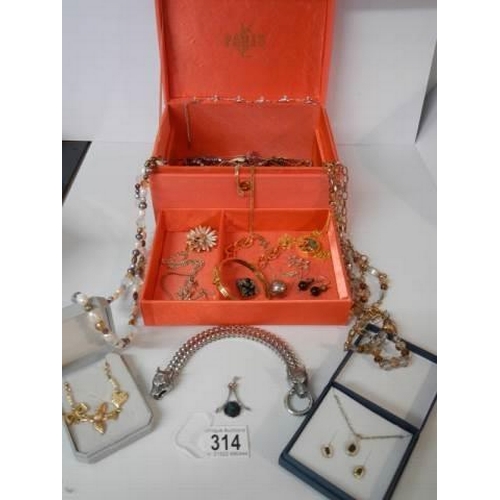 314 - A 'Paris' jewellery box with a mixed lot of costume jewellery.