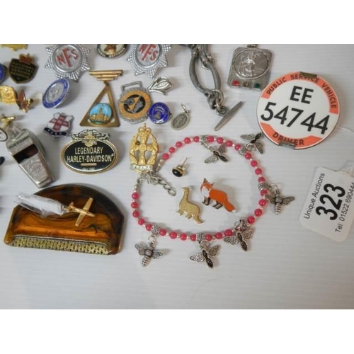 323 - A mixed lot of badges, whistles, brooches etc., (approximately 40 pieces)