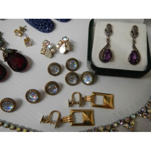 329 - A mixed lot including pendants with matching earrings, sets of buttons etc.,