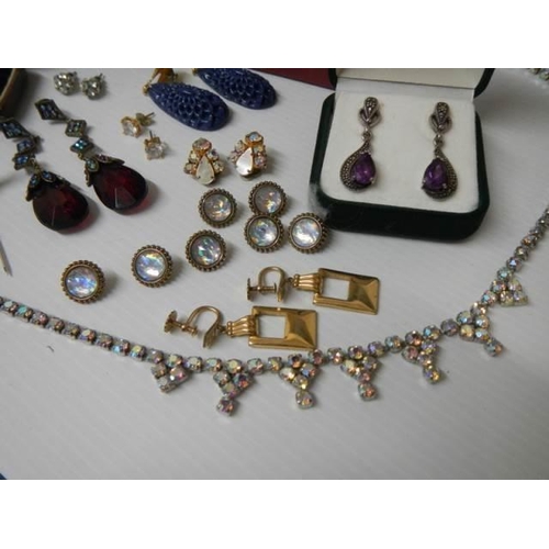 329 - A mixed lot including pendants with matching earrings, sets of buttons etc.,