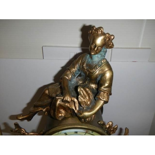 336 - A good 20th century mantel clock surmounted figure and with handpainted dial and panel, with battery... 