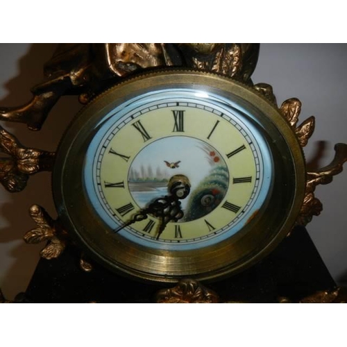 336 - A good 20th century mantel clock surmounted figure and with handpainted dial and panel, with battery... 