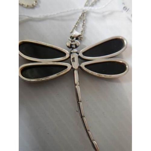 344 - A silver dragonfly pendant with black onyx wings on a silver chain.