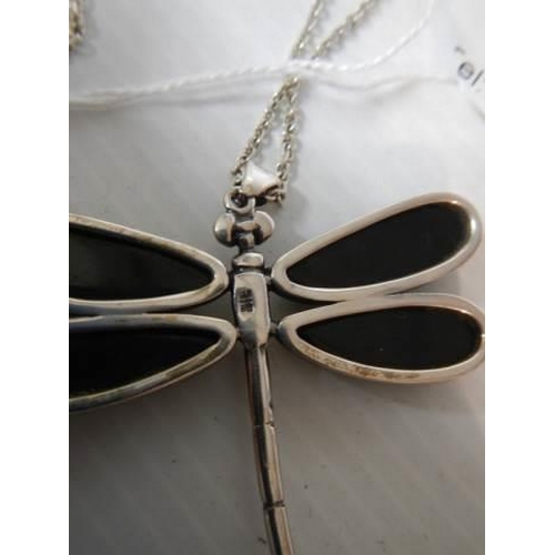 344 - A silver dragonfly pendant with black onyx wings on a silver chain.