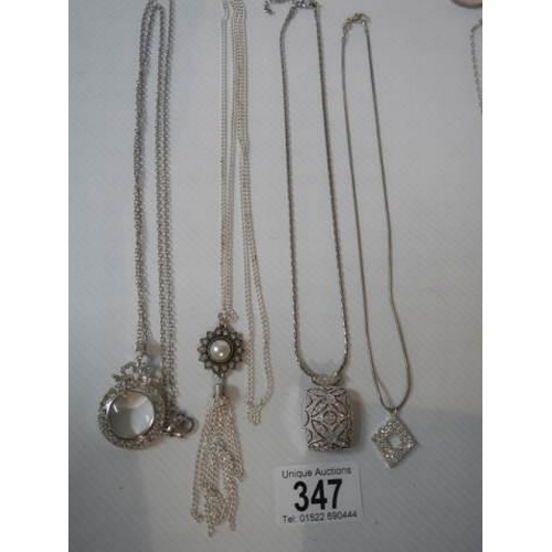 347 - A quantity of necklaces including magnifying glass pendant.