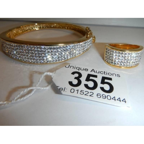 355 - A good quality yellow metal sparkly bangle with matching ring.