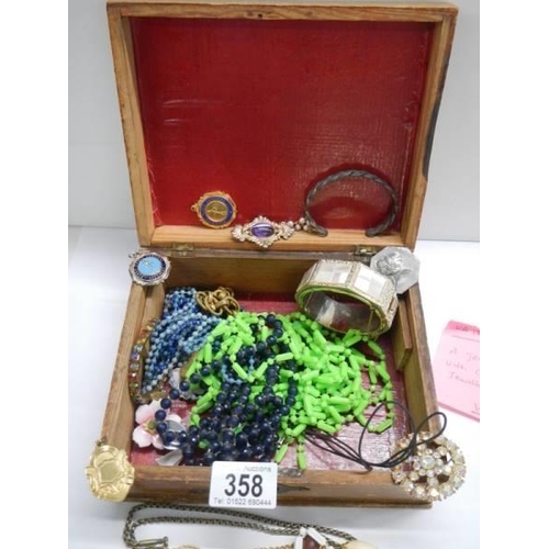 358 - A jewellery box containing assorted costume jewellery.