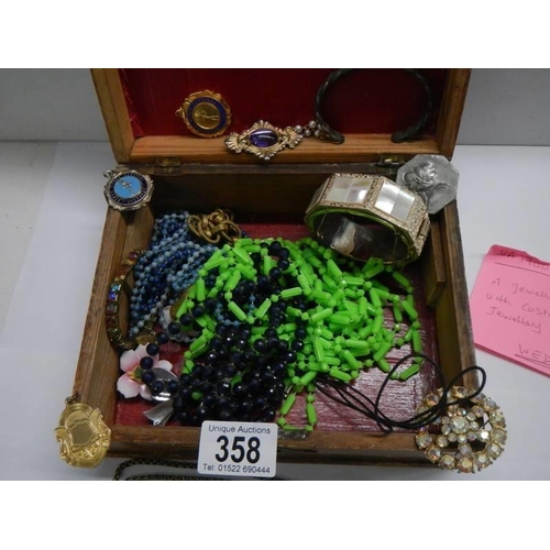 358 - A jewellery box containing assorted costume jewellery.