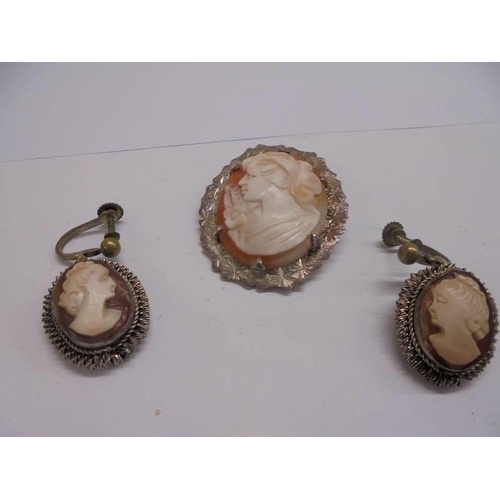 1100D - A silver mounted cameo brooch and a pair of cameo earrings.