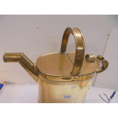 1235 - A large brass watering can.