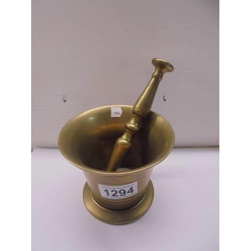 1294 - A brass pestle and mortar.