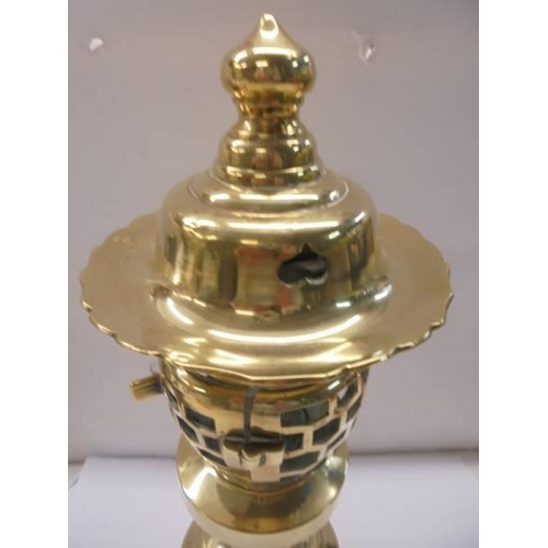 1295 - A rare polished brass lamp, 30 cm tall.