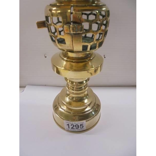 1295 - A rare polished brass lamp, 30 cm tall.