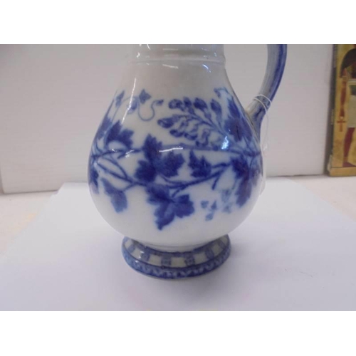 1299 - A 19th century blue and white jug with lozenge mark on base.