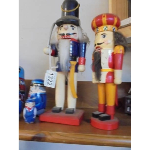 1322 - Two German nutcracker figures and a steam train painted set of Russian dolls.