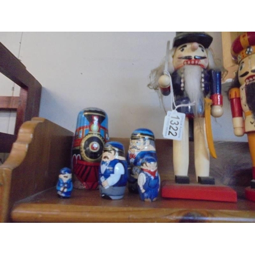 1322 - Two German nutcracker figures and a steam train painted set of Russian dolls.