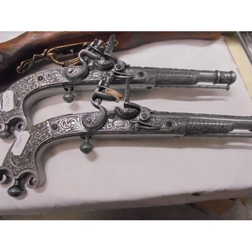 1408 - A replica blunderbus pistol and a pair of replica pistols (for display only).