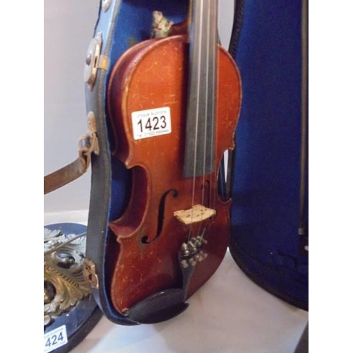 1423 - An old cased violin with two bows.