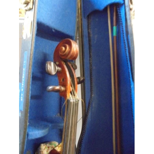 1423 - An old cased violin with two bows.