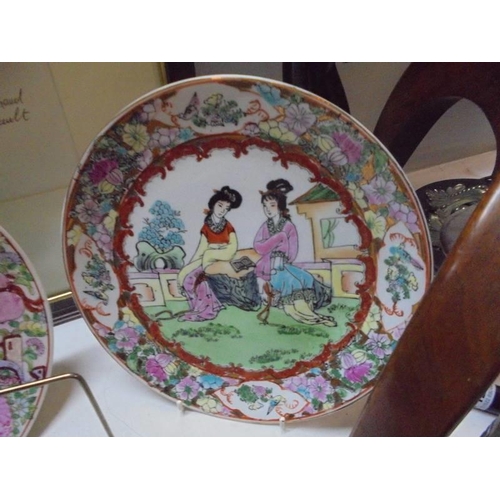 1428 - A hand painted Chinese dish and two hand painted Chinese plates.