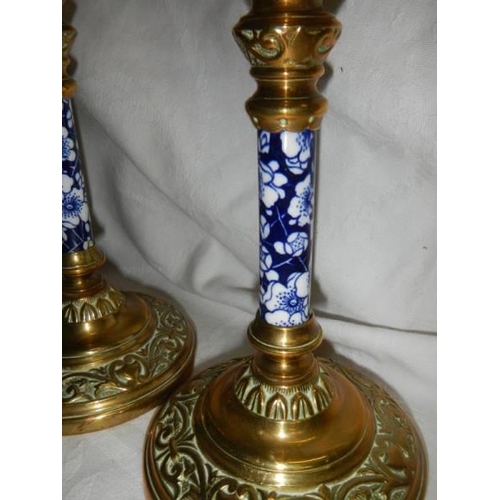 1465 - A pair of good quality Victorian brass candlesticks with unusual blue and white ceramic columns.