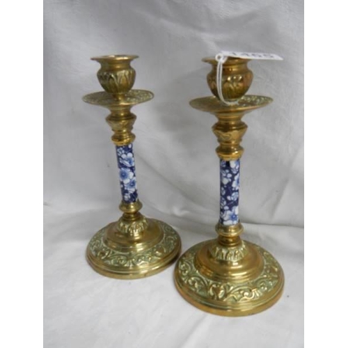 1465 - A pair of good quality Victorian brass candlesticks with unusual blue and white ceramic columns.