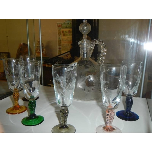 1466 - An Engraved decanter with six engraved glasses on coloured glass stems.