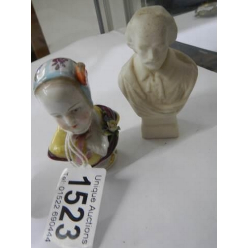 1523 - An early continental porcelain bust paperweight and one other.