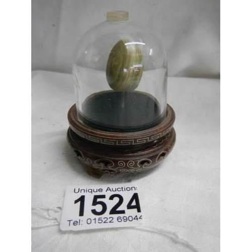 1524 - A mid-20th century Chinese onyx egg under glass dome.