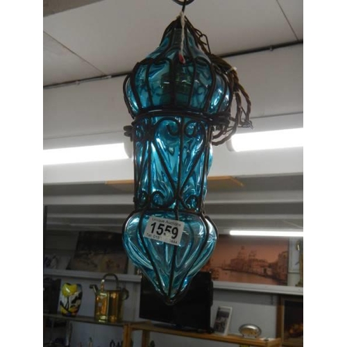 1559 - A turquoise glass and metal porch light.