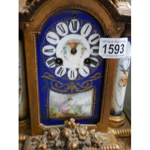 1593 - A French clock with hand painted porcelain panels, (missing hands).