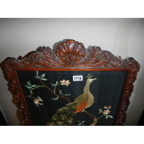 1716 - A mahogany fire screen with embroidered peacock panel. COLLECT ONLY.