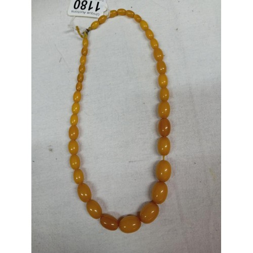 1180 - An amber coloured bead necklace.