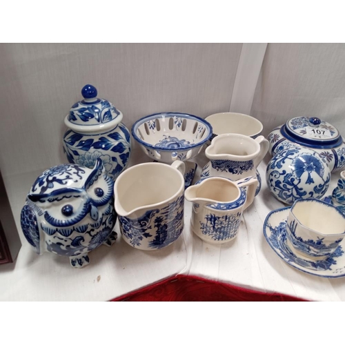 107 - A good lot of blue & white china including large cup & saucer with lozenge mark