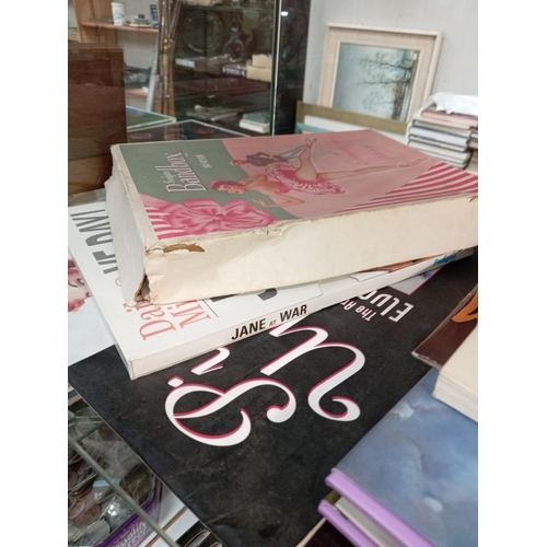 125 - A quantity of books, A calendar & A vintage box depicting erotic ladies