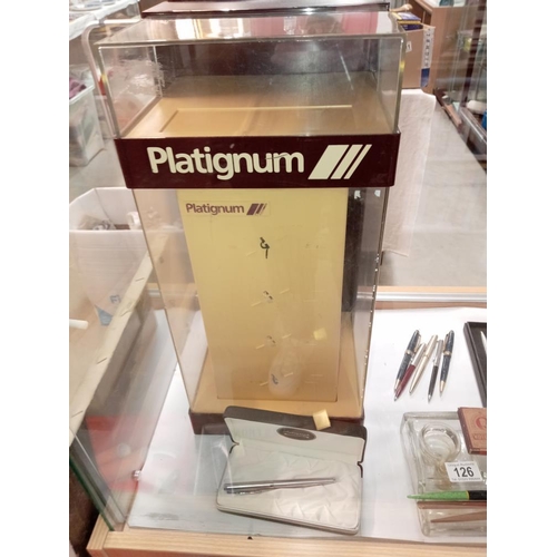 126 - An advertising platignum pen display cabinet inc well & assortment of pens