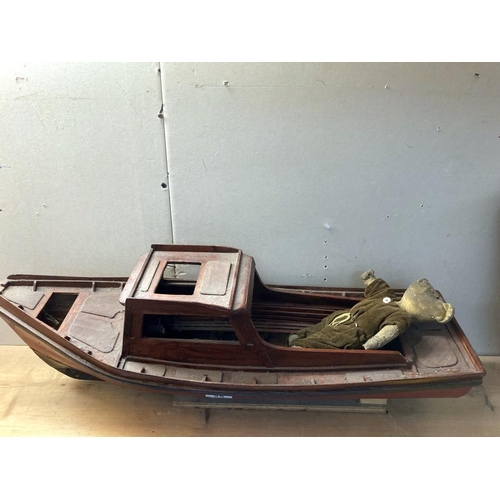 25 - A model boat with an old teddy bear