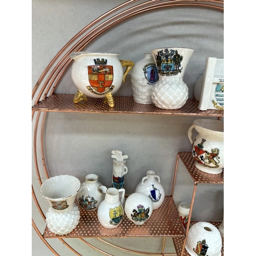 32 - A quantity of crested ware on a copper coloured shelf includes Goss ware