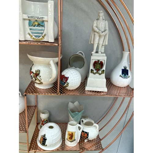 32 - A quantity of crested ware on a copper coloured shelf includes Goss ware