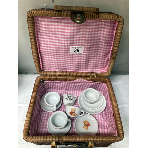 39 - A child's tea set etc in Wicker basket.