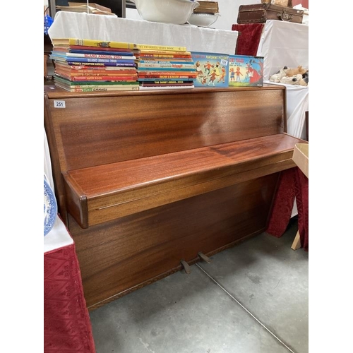 251 - A mahogany upright piano in working condition. COLLECT ONLY