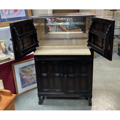 259 - A vintage  dark oak drinks cabinet with mirrored back and 128 h x 81 w x 43d cm COLLECT ONLY