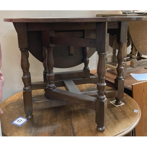 261 - An oak drop leaf table with turned legs and solid supports 100 w x 44 long plus two 47cm leaves  ova... 