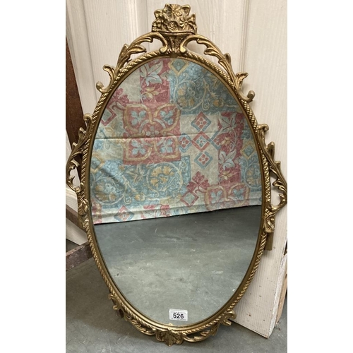 526 - An oval metal framed mirror