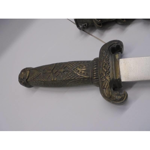 104 - A Chinese dagger in a pagoda style scabbard.