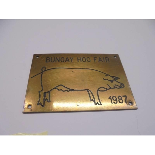 102 - A 1961 RSPCA merit badge and a Bungay Hog Fair 1987 brass plaque.