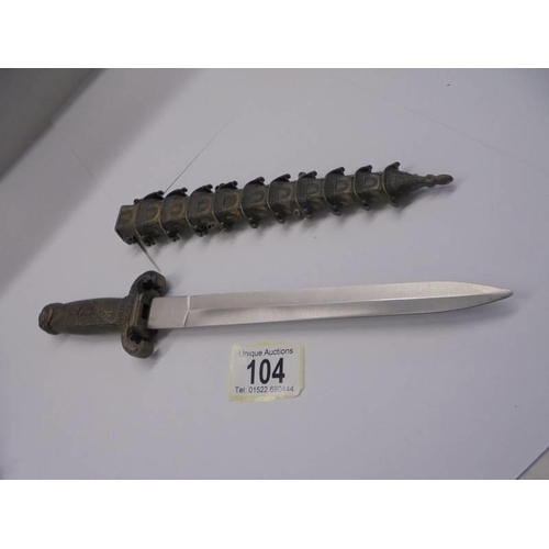 104 - A Chinese dagger in a pagoda style scabbard.