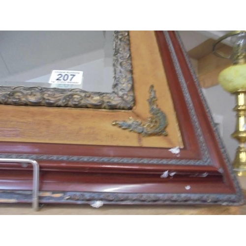 207 - A Bevel edged mirror in a wood and metal frame. COLLECT ONLY.